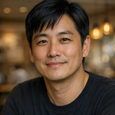 East Asian woman, early 40s, black side-parted hair, calm expression, dark top
